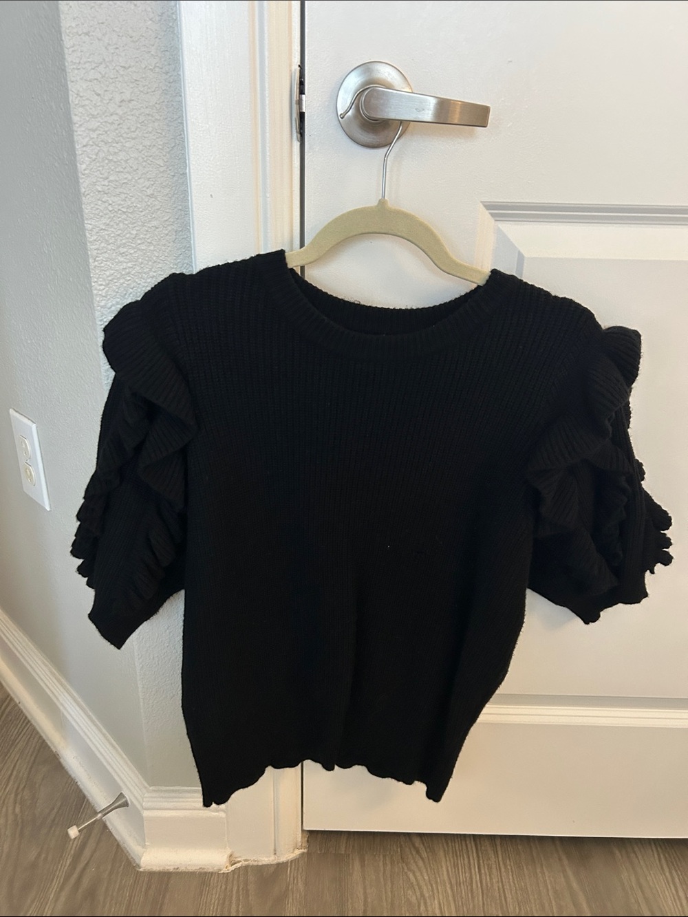 &merci Black Ribbed Knit Top with Ruffle Hem Detail